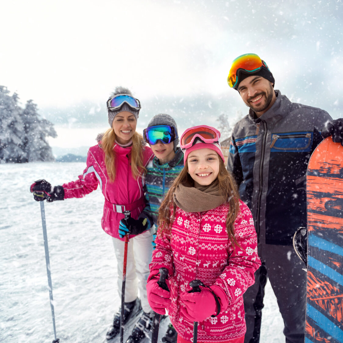 family enjoying winter sports and vacation on snow in mountains smiling family enjoying winter sports and vacation on snow in mountains